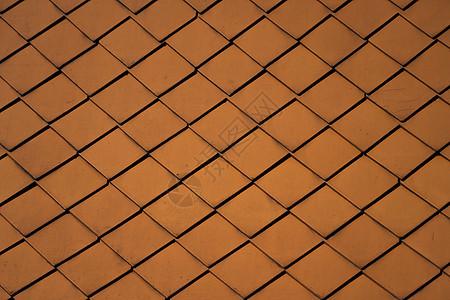 建筑物上的天然橙色屋顶瓦片作为纹理紧固件陶瓷建造钻孔天空橙子建筑材料钻头制品图片