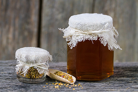 新鲜蜜蜂花粉和蜜蜂花粉液体橙子梳子木头营养药品甜点农业蜂蜡食物图片