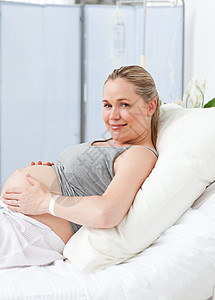在医院床上的怀孕年轻孕妇肚子母性病人女士分娩女性医疗幸福诊所帮助图片