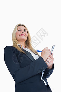 微笑的商业女性在剪贴板上写字图片