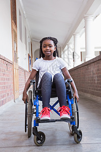 残疾学生在大厅的镜头中微笑走廊童年小学功能女性小学生辅助学校快乐轮椅图片