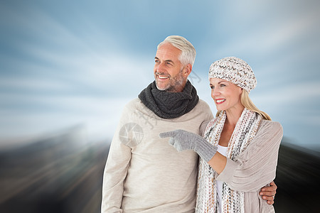 冬季时装的幸福情侣形象综合图象男人保暖男性绘图城市摩天大楼感情建筑手套围巾图片