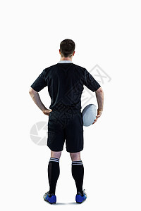 持有橄榄球的橄榄球运动员男人黑色服装播放器运动服竞技男性球衣体育竞赛背景图片