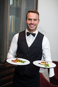 饭食服务员的肖像服务酒店服务员美食衬衫盘子男性餐厅马甲微笑图片