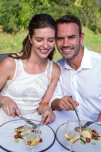 男人和妻子在草坪吃饭的肖像图片