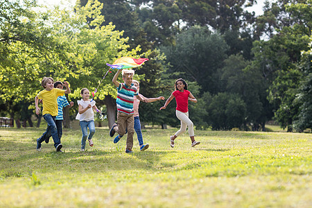 玩风筝的快乐儿童闲暇公园飞行绿地男性草地喜悦童年晴天金发女郎图片