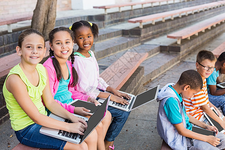儿童坐在长椅上 使用笔记本电脑男生男性休闲童年孩子们女学生网络女孩喜悦女性图片