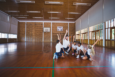 体育教师和在校儿童在篮球法庭打球大厅职业闲暇乐趣健身房男生混血女孩女性快乐图片