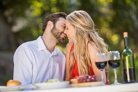 幸福的情侣靠过来接吻亲密感感情酒精晴天食品餐厅女性微笑男人男性图片