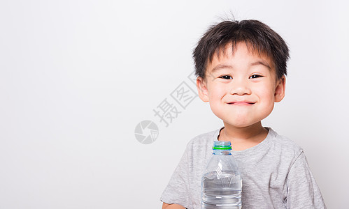 靠近亚洲面孔的亚裔儿童 来自普拉斯的男孩饮用水矿物饮料瓶装淬火保湿瓶子液体保健孩子们青年图片