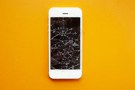 橙色背景上智能手机的碎屏玻璃屏幕展示事故服务电脑商业工具技术裂缝图片