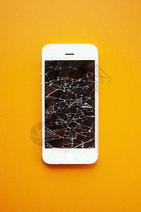 橙色背景上智能手机的碎屏橙子屏幕展示事故休息失败细胞维修碰撞电脑图片