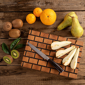 木制切割板上有刀子的水果营养工作室正方形小吃绿色食物生产橙子木板服务图片