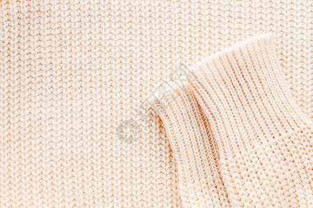 抽象针织的背景 有袖羊毛衫 针织图案的特写图片纺织品衣服平行线套衫袖子羊绒羊毛白色编织宏观图片