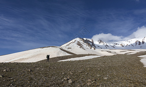 游客从山坡上爬到雪顶顶顶峰探索远足登山者成就登山自由太阳男人山脉远足者图片