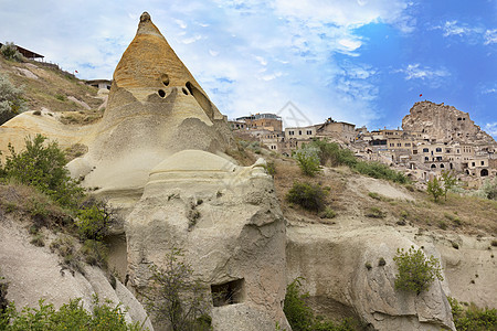 卡帕多西亚山的住宅洞穴文化天空地区爬坡岩石历史地形房子蓝色城市图片