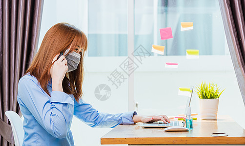 身戴面罩的女商务人士在办公桌上工作职场家务感染凝胶女性卫生女孩电脑流感技术图片