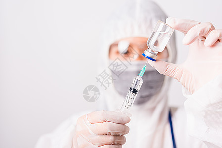 在实验室穿个人防护设备套装的PPE医生或科学家持有利药流感疫苗瓶子玻璃药品注射小瓶装备科学治疗图片