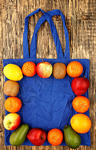 传统蓝色的生态友好棉花袋 以木制背景为果实种植图片