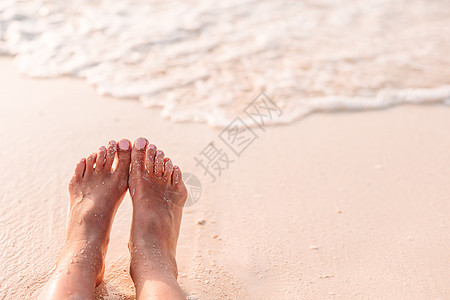 在浅水的白沙滩上 女人的脚身体闲暇女孩蓝色热带游客旅行棕褐色阳光女士图片