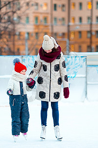 可爱的小女孩 妈妈和妈妈在冰加冰上滑冰冰鞋学习女儿速度闲暇教学数字童年幸福溜冰场图片