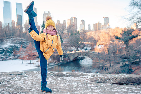 纽约市中央公园冰场的风景引来可爱的小姑娘石头溜冰者操场溜冰场孩子乐趣童年城市建筑物摩天大楼图片