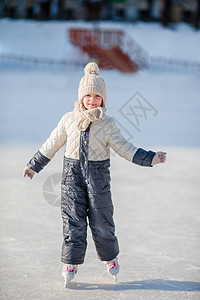 可爱的小女孩在户外冰场滑冰图片
