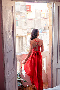 在哈瓦那公寓的旧阳台 穿着红色礼服的年轻有吸引力的女人裙子城市女性热带情调娱乐闲暇异国黑发女孩图片