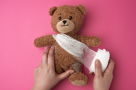 棕色泰迪熊 带绷带的躯体和白纱布图片