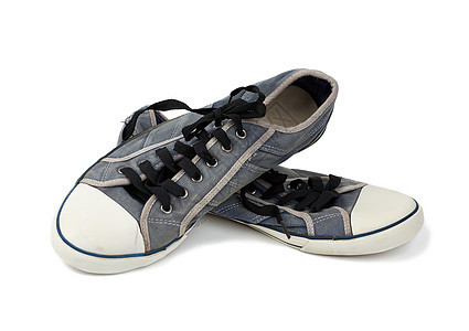 黑色鞋带的一对蓝色穿戴的纺织运动鞋图片