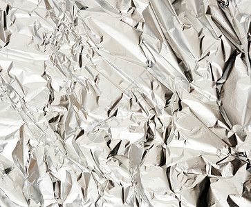 哑光皱巴巴的铝箔食品和物品包装的质地皱纹折叠材料挫败床单锡纸光泽度反射金属背景图片