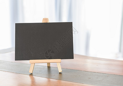 白色房间木桌边的黑板图片