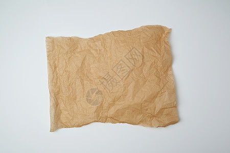 白色背景上撕破的棕色羊皮纸纸板材料工艺牛皮纸床单黄色回收边缘笔记损害图片