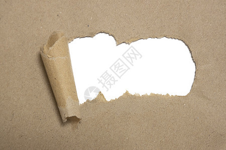 撕破的棕色包裹卷起带有空白白色副本的曲线纸图片