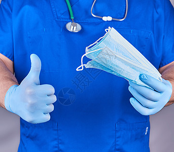 穿制服的医生和穿蓝乳胶手套戴消毒面具医院卫生疾病蓝色关心白色治疗实验室医疗外科图片