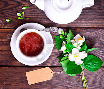 热黑茶蒸汽黑色饮料茉莉花绿色茶壶木板叶子桌子棕色图片