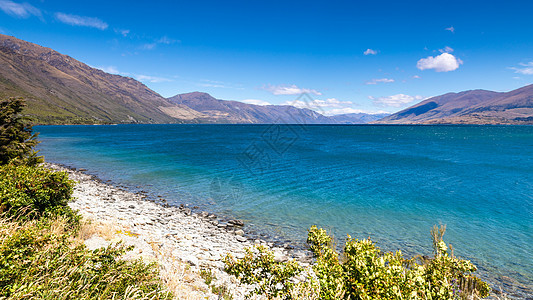 Wanaka湖新西兰南部岛屿草地顶峰爬坡天空农村蓝色全景反射晴天旅行图片