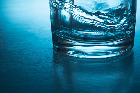 将水倒入蓝色背景的玻璃中飞溅口渴气泡喷泉环境运动茶点卫生流动美丽图片