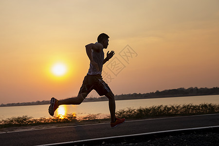 英俊的年轻人在夏天日落时 在农村公路上奔跑f重量耐力跑步慢跑者天空活动卫生行动男性成人图片