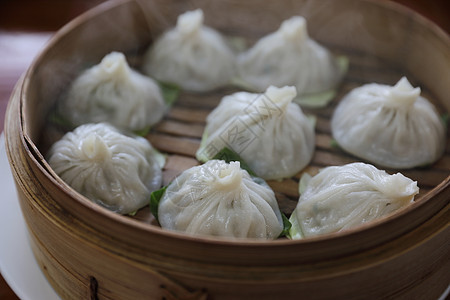 竹篮 中国菜的酱面粉美食盘子猪肉蒸汽食物餐厅饺子竹子大豆用餐图片