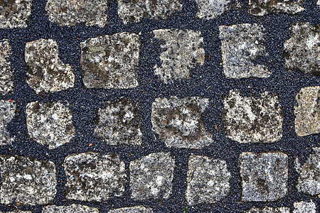 详细特写古老的鹅卵石道路和步行道材料街道小路历史路面铺路正方形地面石头岩石图片