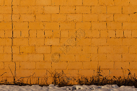 橙色石膏粗糙砖外墙纹理染料建筑裂缝长方形平面建筑学材料墙纸粮食日光背景图片