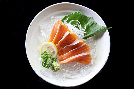 近距离闭紧的鲑鱼生鱼鱼肉海鲜午餐鱼片红色食物餐厅美食寿司白色宏观图片