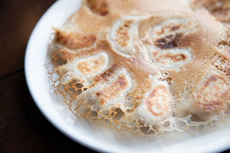 日本菜 盘子上的青藏平底锅午餐水饺蔬菜美食筷子大豆小吃烹饪芝麻图片