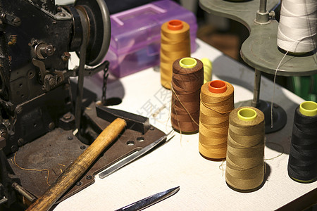 在古代缝纫机上铺设的 聚酯缝纫线图片