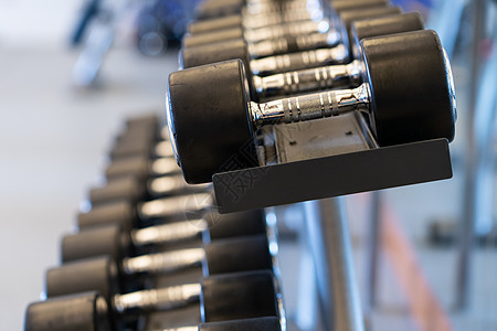 健身房架架上闭合一排金属哑铃锻炼身体架子建筑举重权重杠铃重量肌肉训练图片