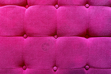 粉红色天鹅绒沙发纹理背景的特写表面图片
