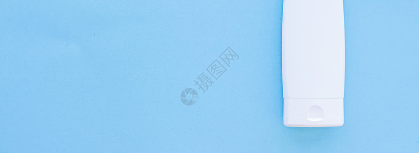 白标签化妆品容器瓶 作为蓝底产品模拟的蓝色面料护理肥皂凝胶卫生管子保健保湿消毒剂润肤皮肤图片