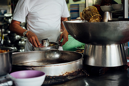 厨师在街头食品市场煮面汤男性食物美食文化旅行猪肉蔬菜市场餐饮午餐背景图片