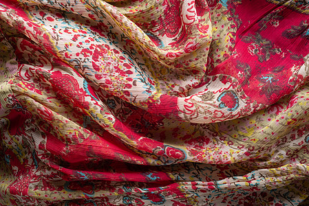 丰富多彩的合成织物纹理材料古董装饰品方巾衣服黄色金子红色敷料纤维图片